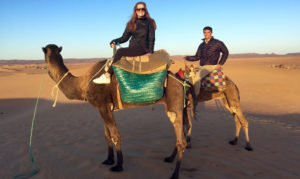 student sitting on a camel