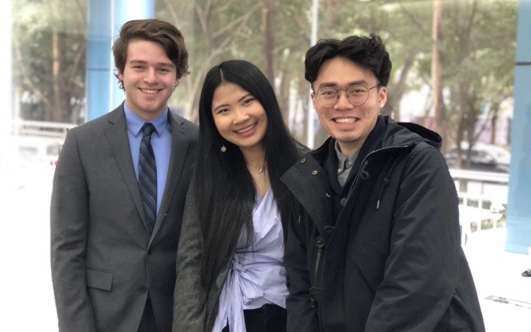 Three students smiling