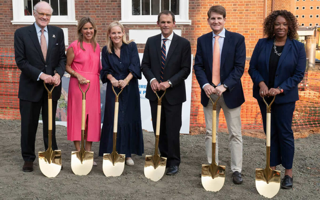 From left to right, UVA Rector Whittington Clement, Virginia First Lady Suzanne Youngkin, Carrie Shumway, President Jim Ryan, Chris Shumway and McIntire School of Commerce Dean Nicole Thorne Jenkins put shovels into dirt, kicking off the school’s new expansion. (Photo by Dan Addison, University Communications)