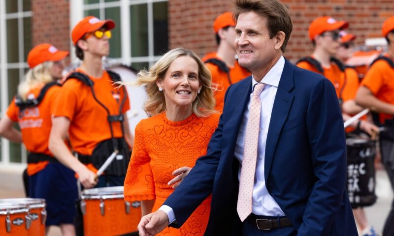 Members of the Cavalier Marching Band play as Carrie and Chris Shumway prepare to enter the new Shumway Hall at the McIntire School of Commerce. (Photo by Allen Hoover)