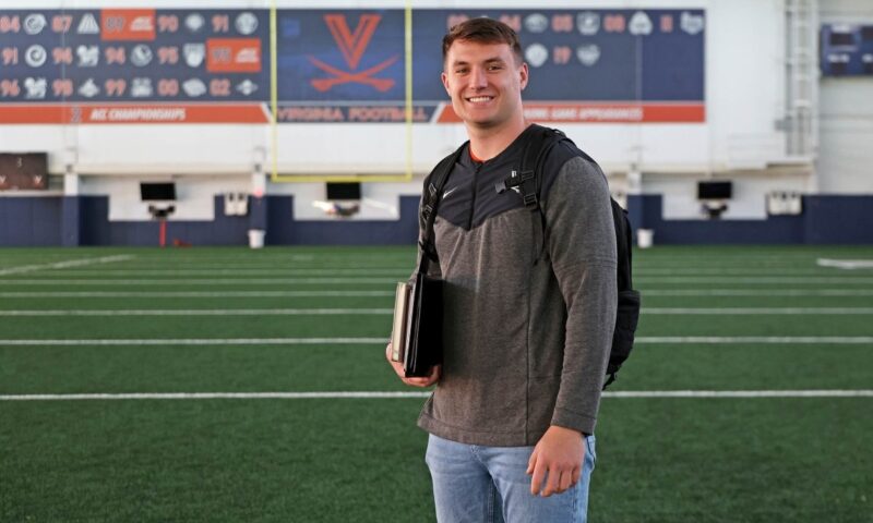 Trey McDonald posing on a football field