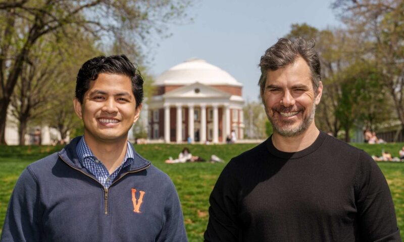 Romeo Sarmiento and Mike Rose stand on the Lawn with the Rotunda in the distance. Both veterans have dedicated themselves to making UVA more accessible and welcoming to students who have served in the military. (Photo by Lathan Goumas, University Communications)