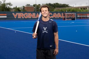 Webb poses at Turf Field ahead of a UVA field hockey practice. The McIntire School of Commerce student often splits his days between the field and the Breeden Commerce Grounds. (Photo by Matt Riley, University Communications)