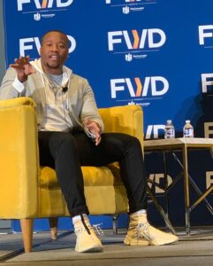 Minnifield speaks at a conference on behalf of EZOS, the AI-powered property management software company he founded in 2018. (Contributed photo)