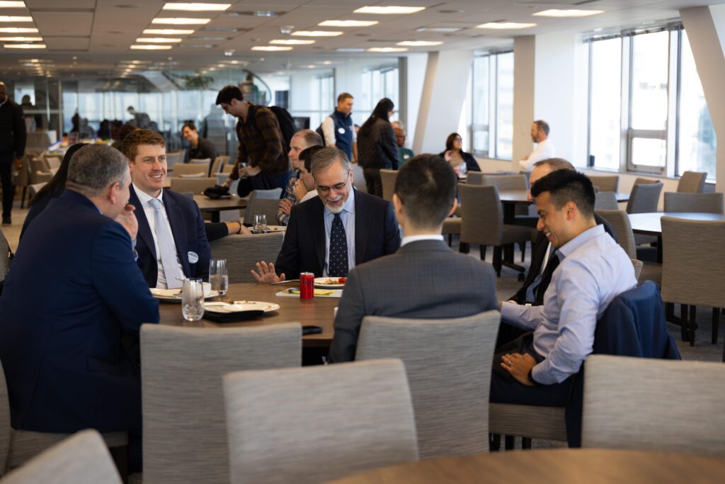 MSMIT students and Professor Stefano Grazioli seated at a table eating