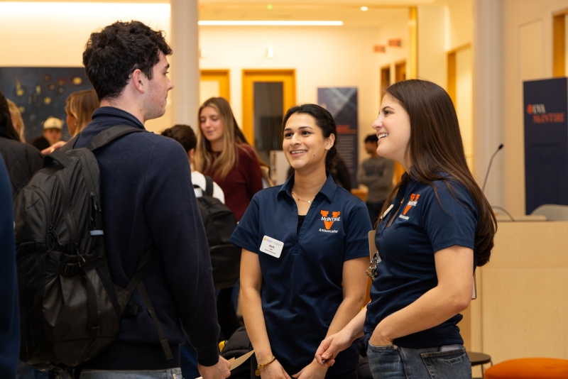 Margo Kaye and fellow McIntire Ambassador speaking with a student