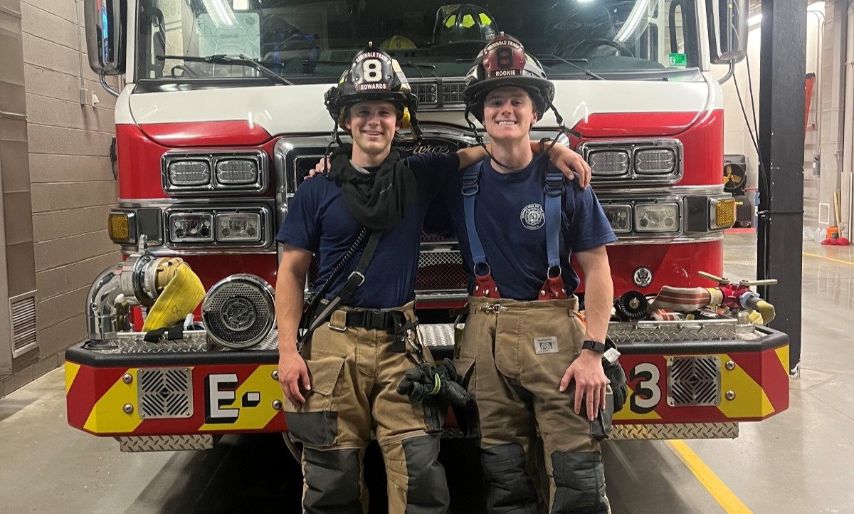 Alex Edwards and Mike Edwards in firefighter gear at the Seminole Trail fire station