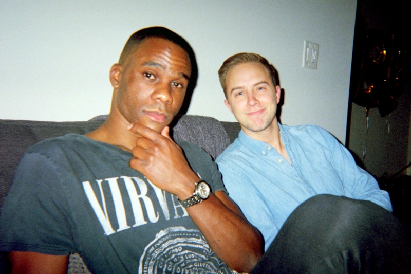 Durst and Pollard pose together sitting on a couch