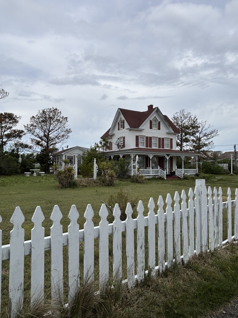 a house with a picket fence in the foreground