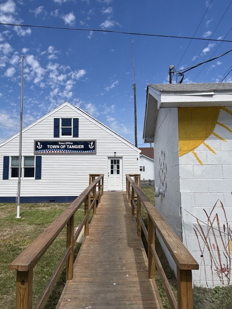 a wooden ramp leading to a building with a sign that says Town Office, Town of Tangier