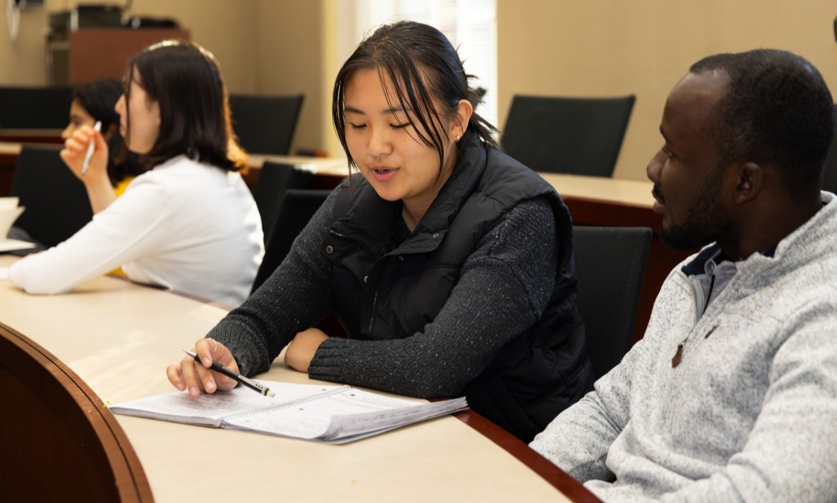 two MSA students sitting at a desk and talking