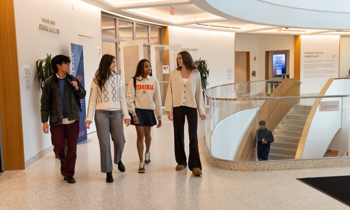 four students walking in a hallway