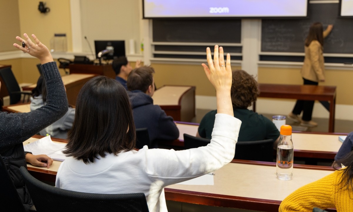 students learning from a professor in a classroom